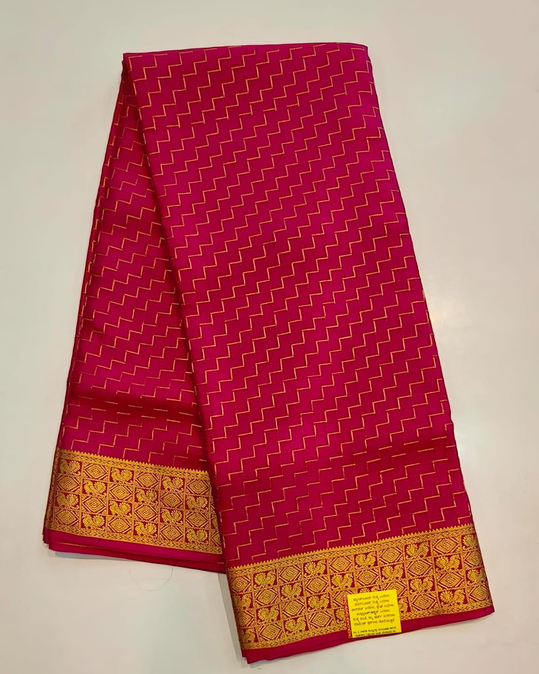 Rani pink pure Mysore silk crape saree with gold zigzag weave and traditional zari border