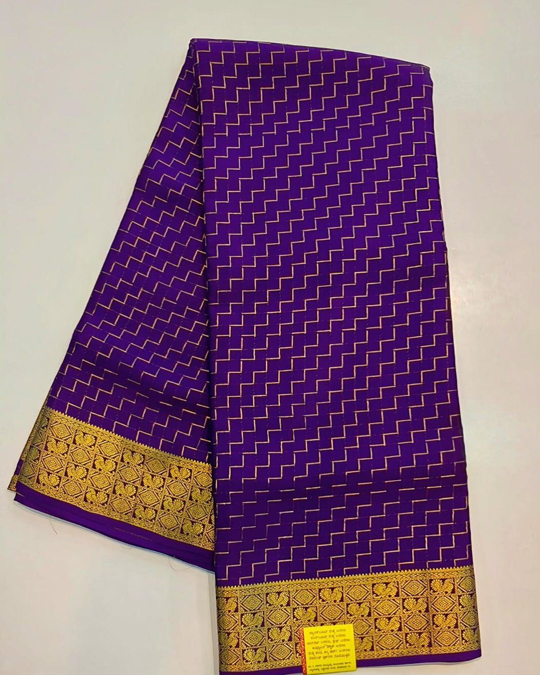Violet pure Mysore silk crape saree with gold zigzag pattern and peacock zari border